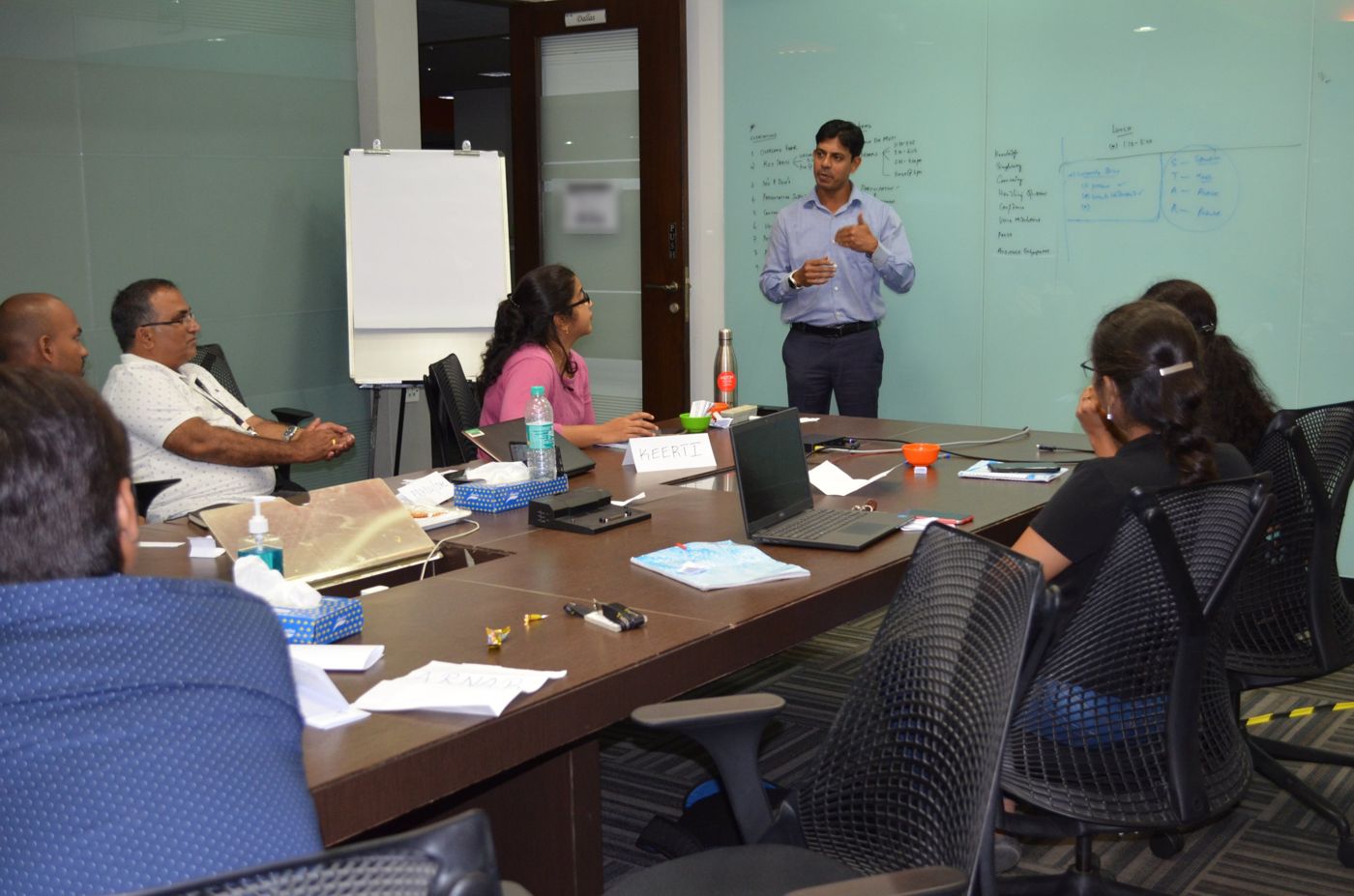 Umesh coaching participants around a conference table